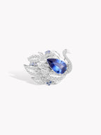 Swan sapphire ring with oval blue center stone and sparkling pave crystal accents