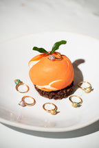 Gold-tone fruit charm rings, including orange fruit with green leaf and small stones