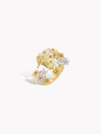 Gold ring with floral design of round stones, white and yellow accents