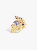Gold grape-vine cluster ring with purple sapphire center and small gemstone accents
