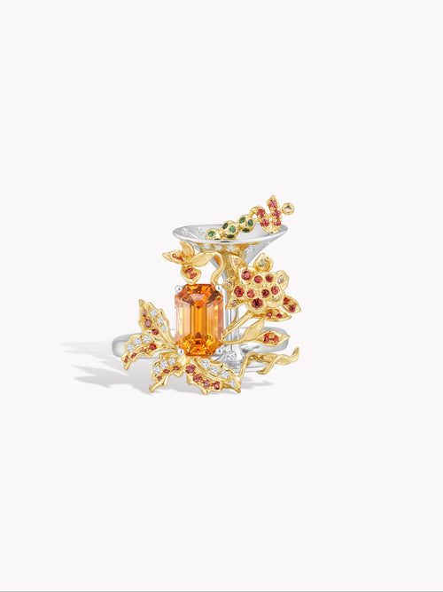 Cocktail ring with orange marquise center stone and floral prong setting, gold-tone accents