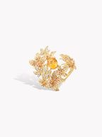 Gold-tone maple leaf open ring with sparkling yellow stones, side angle