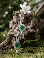 Linear drop earrings with square emerald-green center stones and pavé clear accents