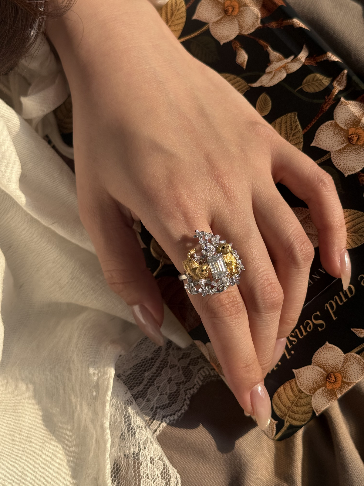 Diamond puppy and floral ring with a gold-toned setting and clear stones