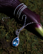 Aquamarine diamond teardrop pendant necklace with blue drop stone on silver chain