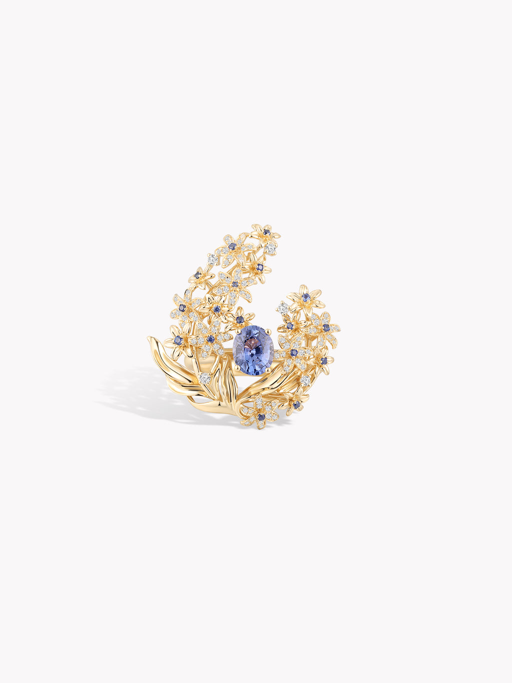Gold-tone ring with blue sapphire center and diamond-like floral halo, angled front