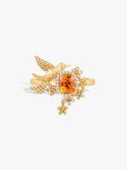 Gold-tone bird ring with orange center stone and diamond pavé bird detail
