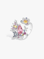 Butterfly ring with pink teardrop center stone and blue and yellow gemstone accents