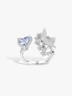 Open ring with heart-cut blue sapphire and white stone floral clusters