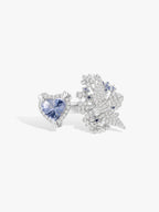 Open ring featuring heart-cut blue sapphire with white stone cluster design