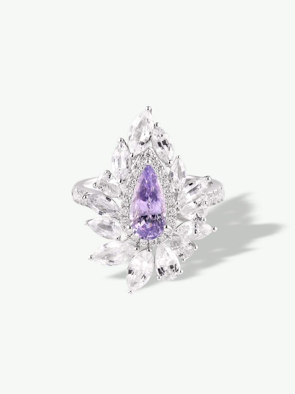 Purple marquise gemstone cluster ring with leaf-like halo and prong-set stones
