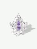 Purple marquise gemstone cluster ring with leaf-like halo and prong-set stones