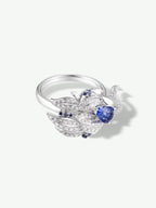 Swan-shaped silver ring with teardrop blue sapphire and pavé accents