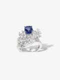 Sapphire blue gemstone ring with square center and diamond-like geometric halo