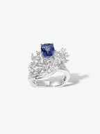 Sapphire blue gemstone ring with square center and diamond-like geometric halo