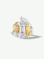 Diamond puppy and floral ring; central baguette stone with two gold-tone puppy figures