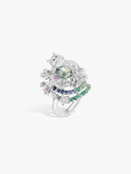 Cat-shaped silver ring in angled view with green center stone and multicolor halo