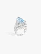 Aquamarine wing ring in silver-tone with pear-cut blue stone and beaded pearl band