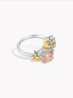 Test ring side view with silver band, peach and clear stones, gold accents