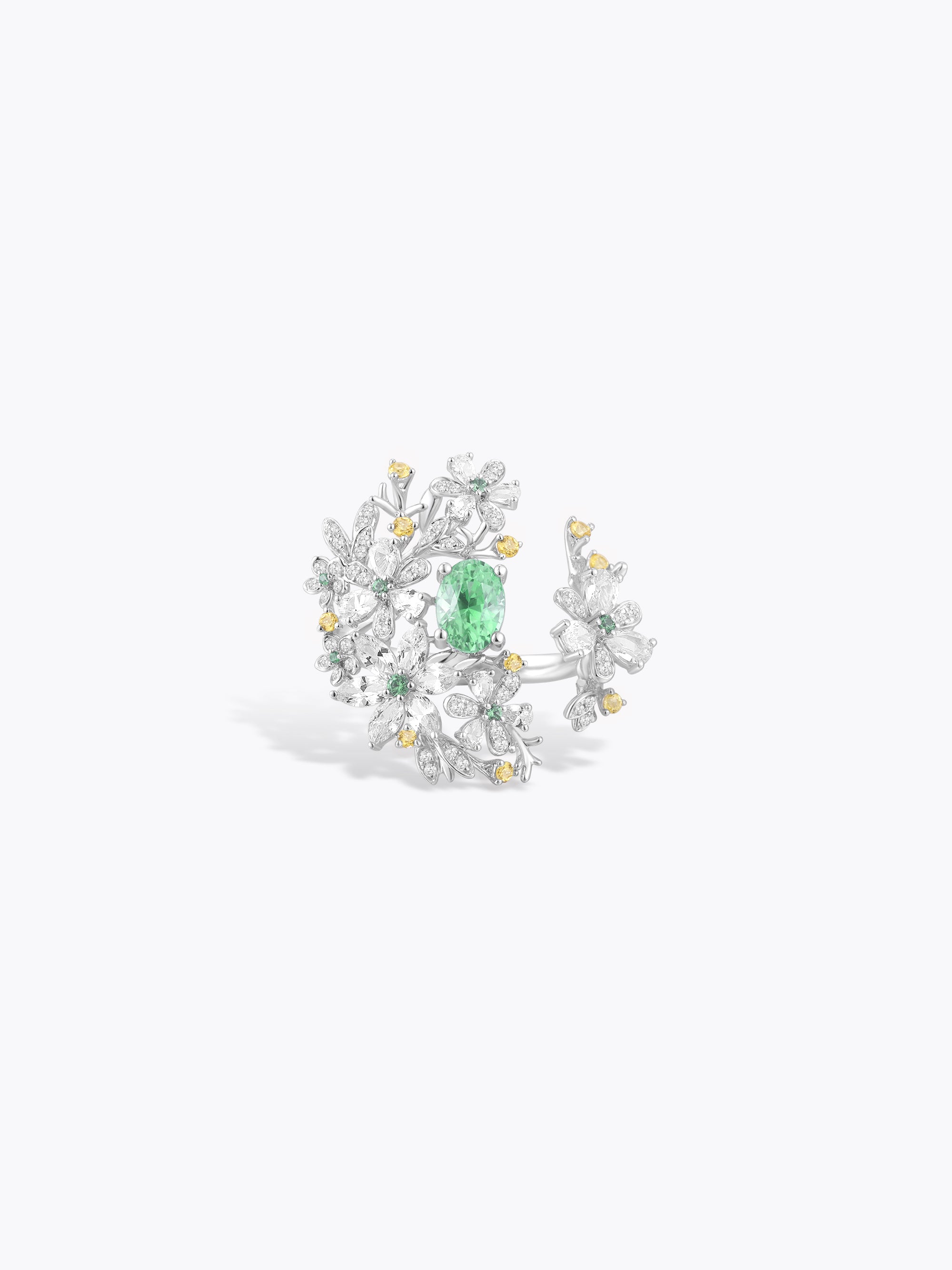 Floral branch ring with green center stone and white gem accents with gold details