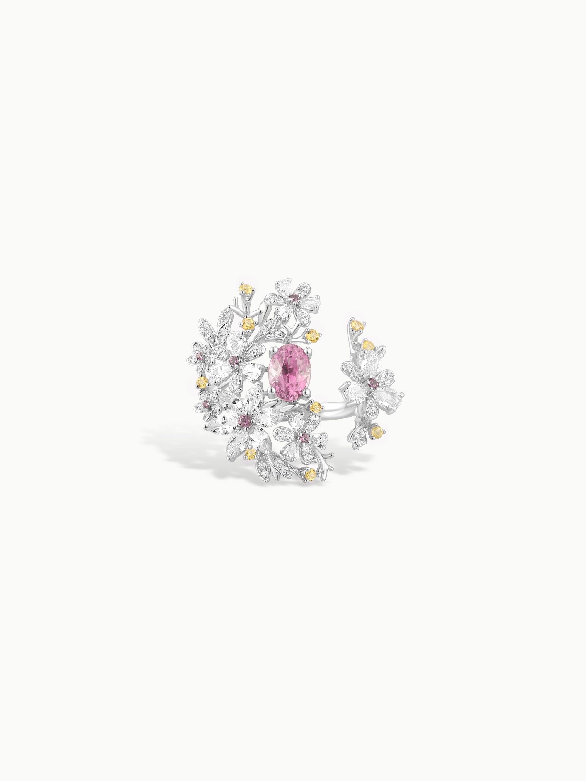 Floral branch ring with pink center stone and white gem accents with gold details