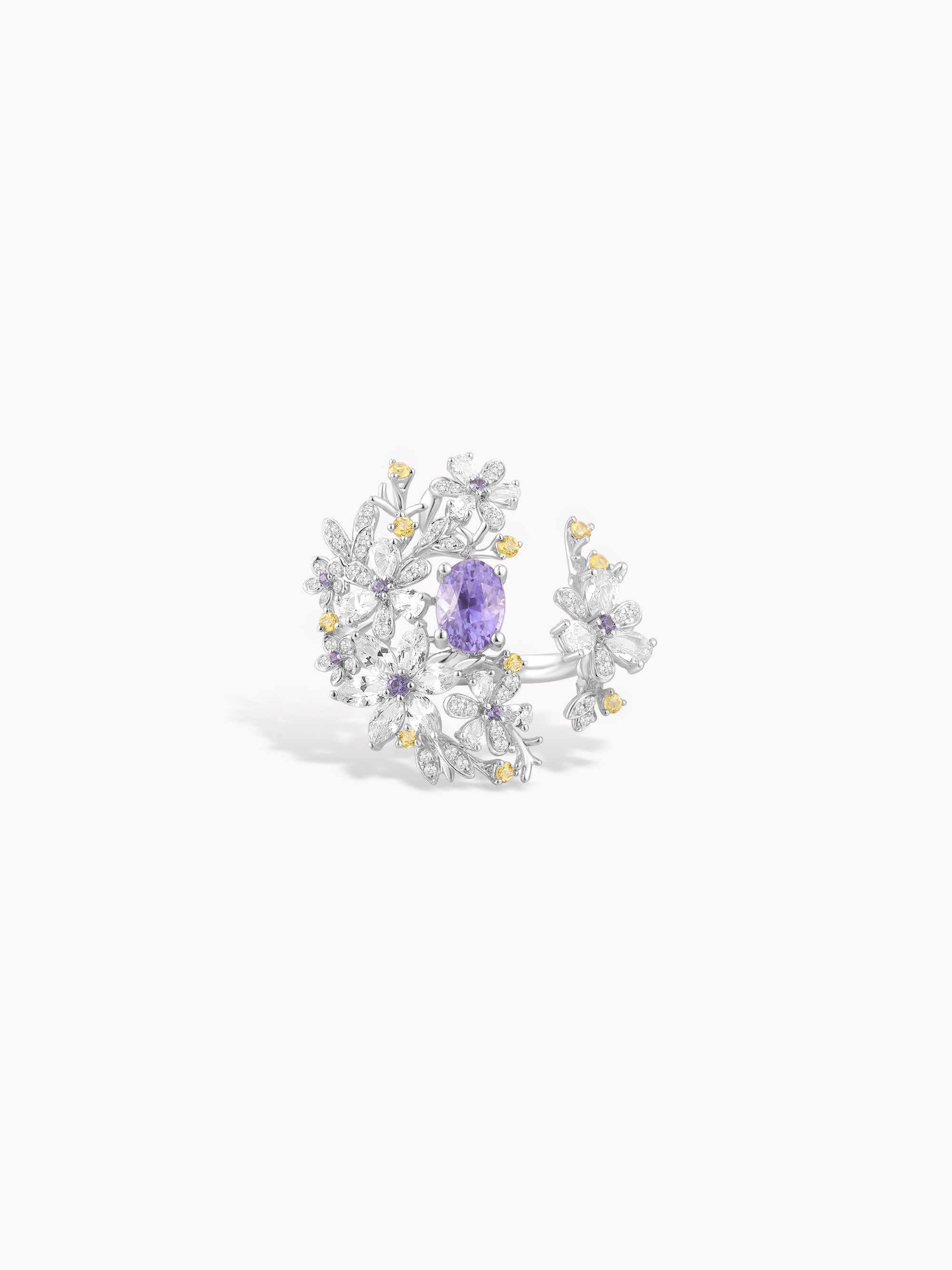 Floral branch ring with purple center stone and white gem accents with gold details