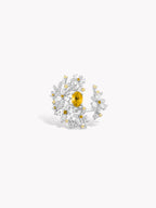 Floral branch ring with yellow center stone and white gem accents with gold details