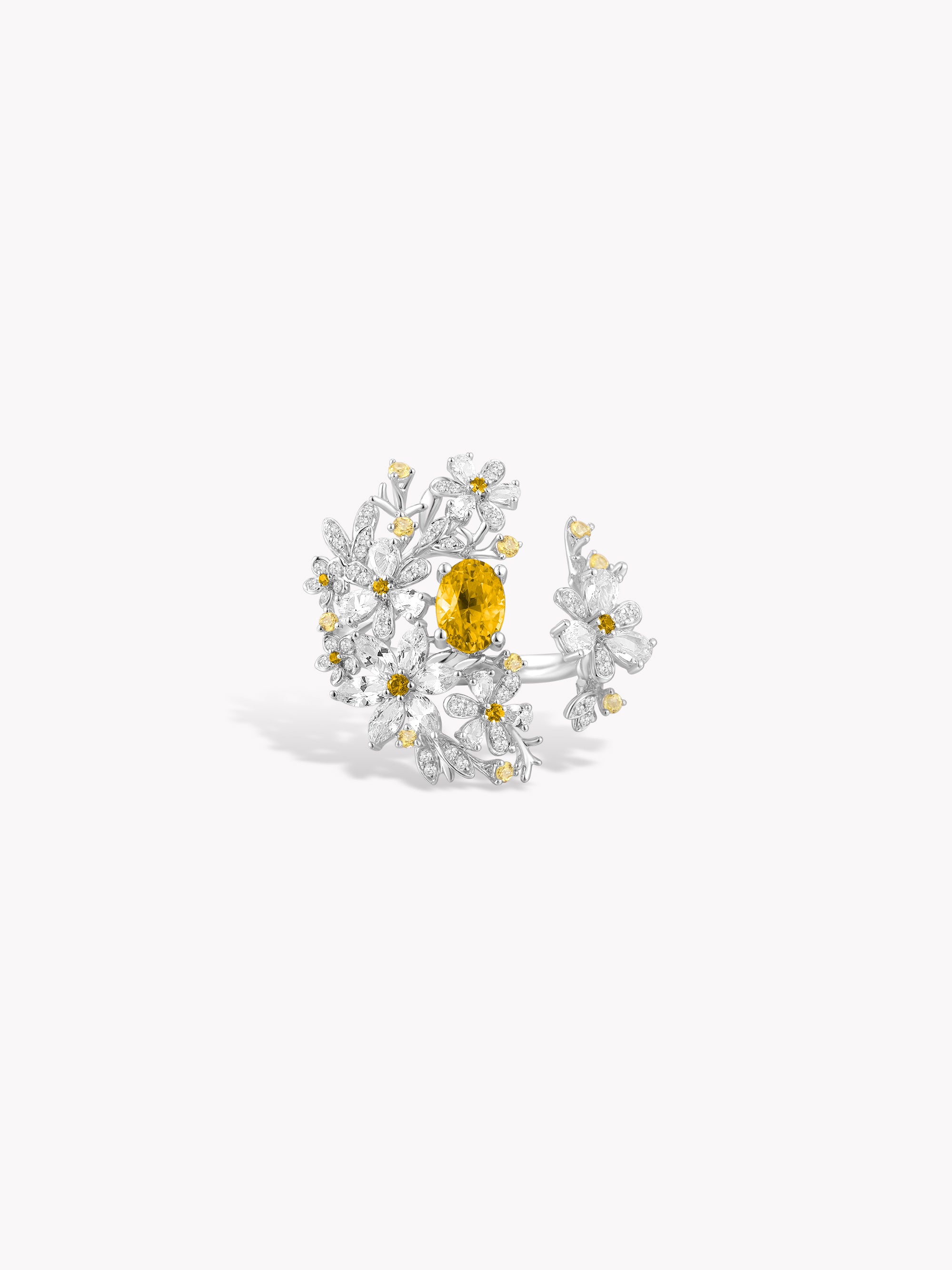 Floral branch ring with yellow center stone and white gem accents with gold details