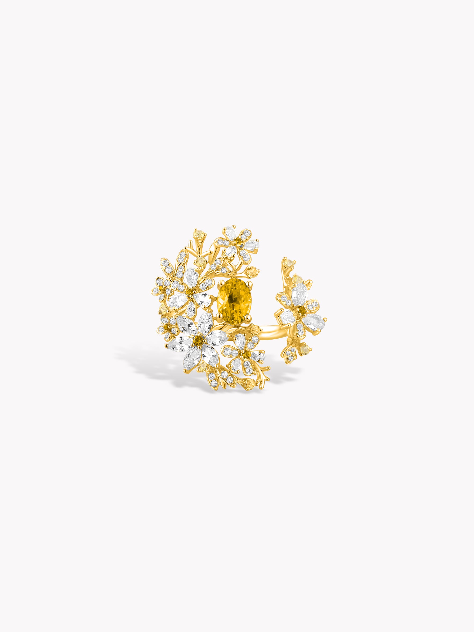 Floral branch ring with yellow center stone and golden-toned gem setting